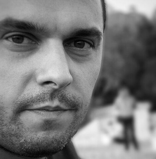 Barber 1 young man with beard smiling and wearing a  brown shirt
