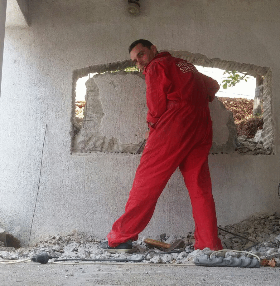 man with quiff and brown tinted sunglasses wearing a fur collar